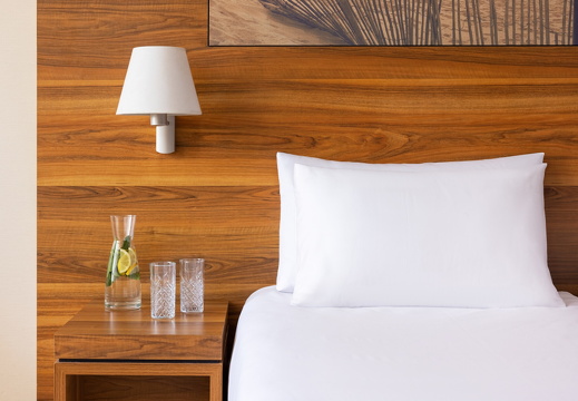 NH Zandvoort Rooms Detail Bed Headboard Pillows Water Jug And Water Glasses On Bedside